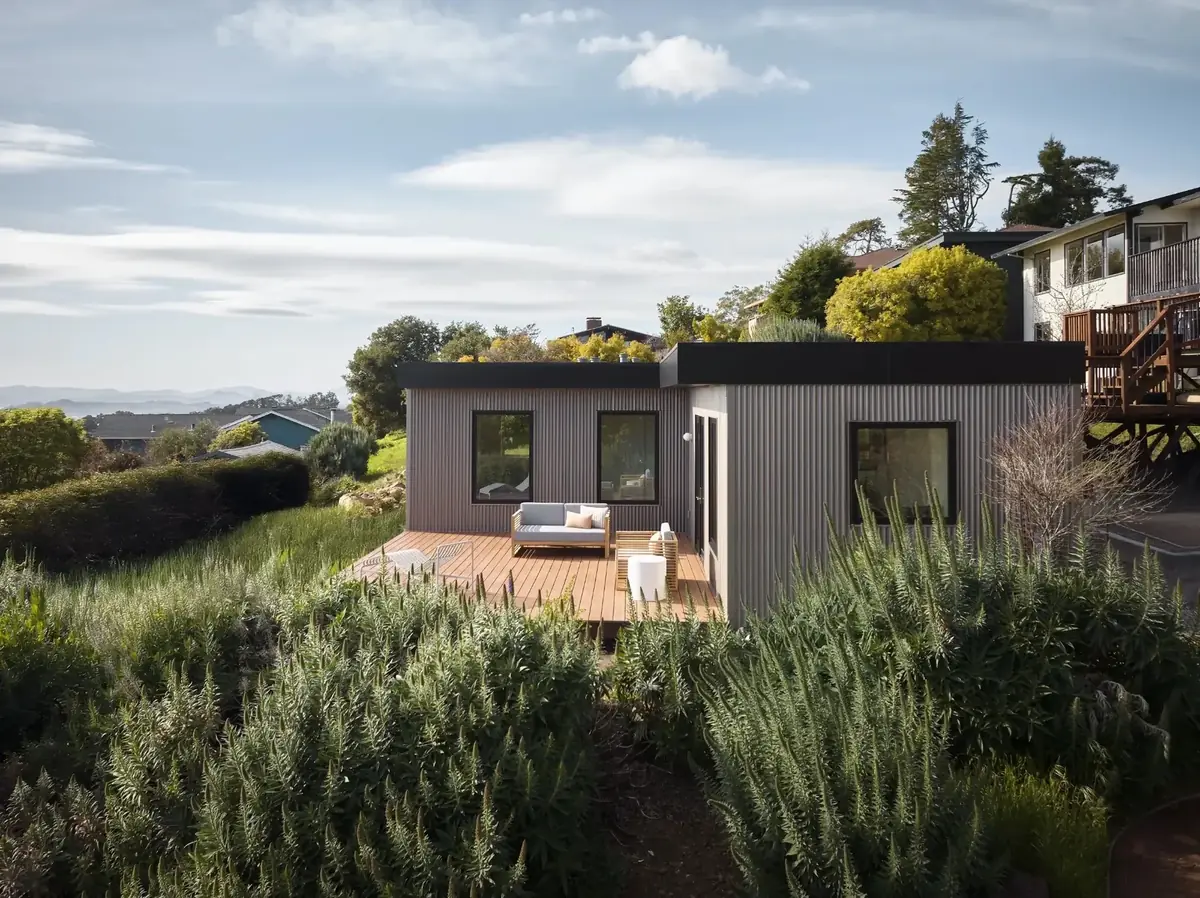 Modular ADU with corrugated metal exterior installed in a Bay Area backyard