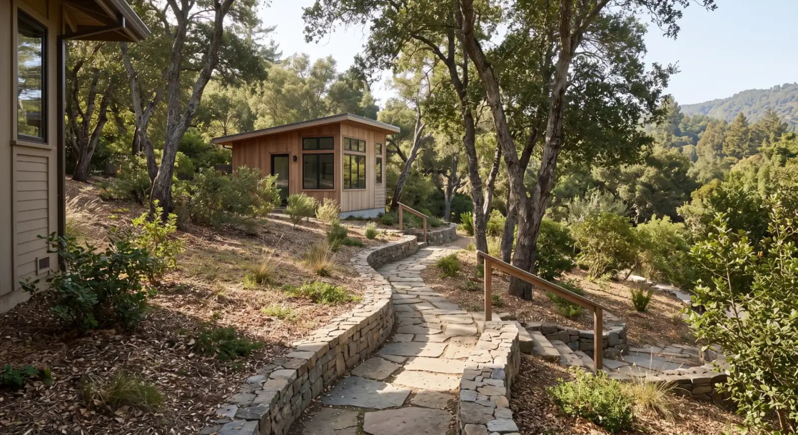 Illustrative garden path following a gentle wooded slope toward an ADU entrance.