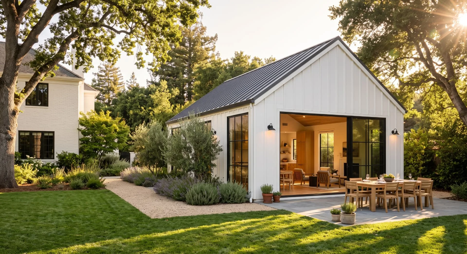 White board-and-batten ADU with steel windows in a landscaped West Menlo Park garden